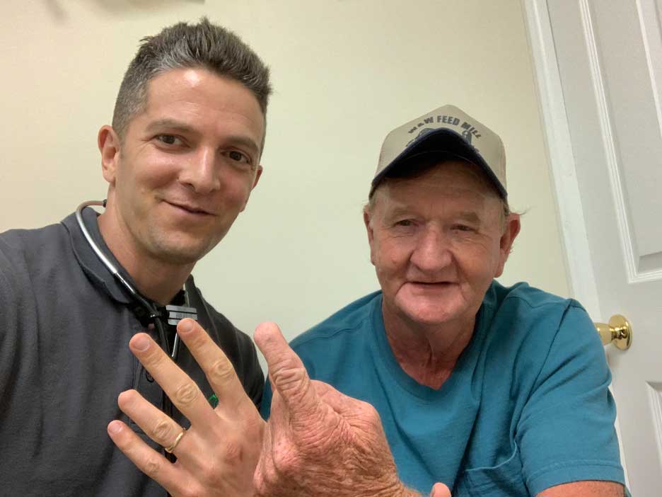 Drew Harris and a coal miner showing their partial finger amputations