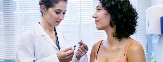 A clinician preparing to administer a vaccine to a patient