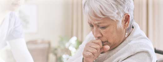 Elderly woman coughing