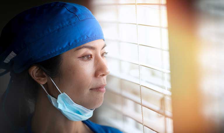 a clinician looking out a window