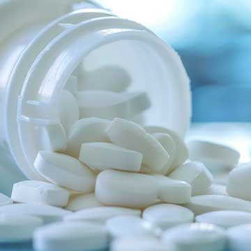 White pills spilling out of a bottle